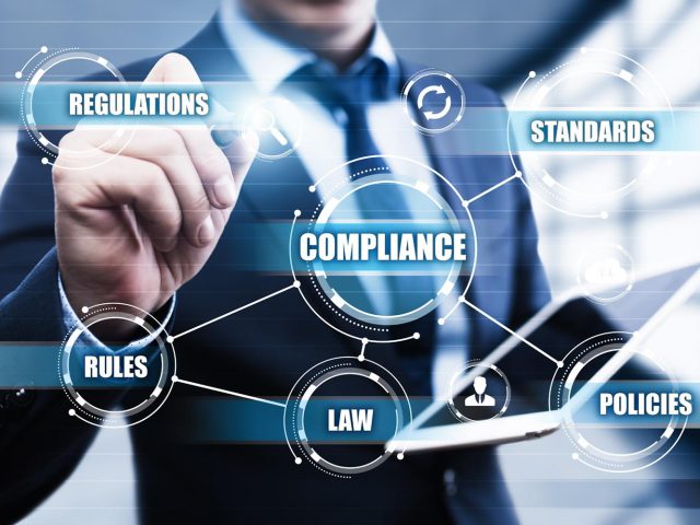 Compliance Rules Law Regulation Policy Business Technology concept businessman pressing button on virtual screens in modern office