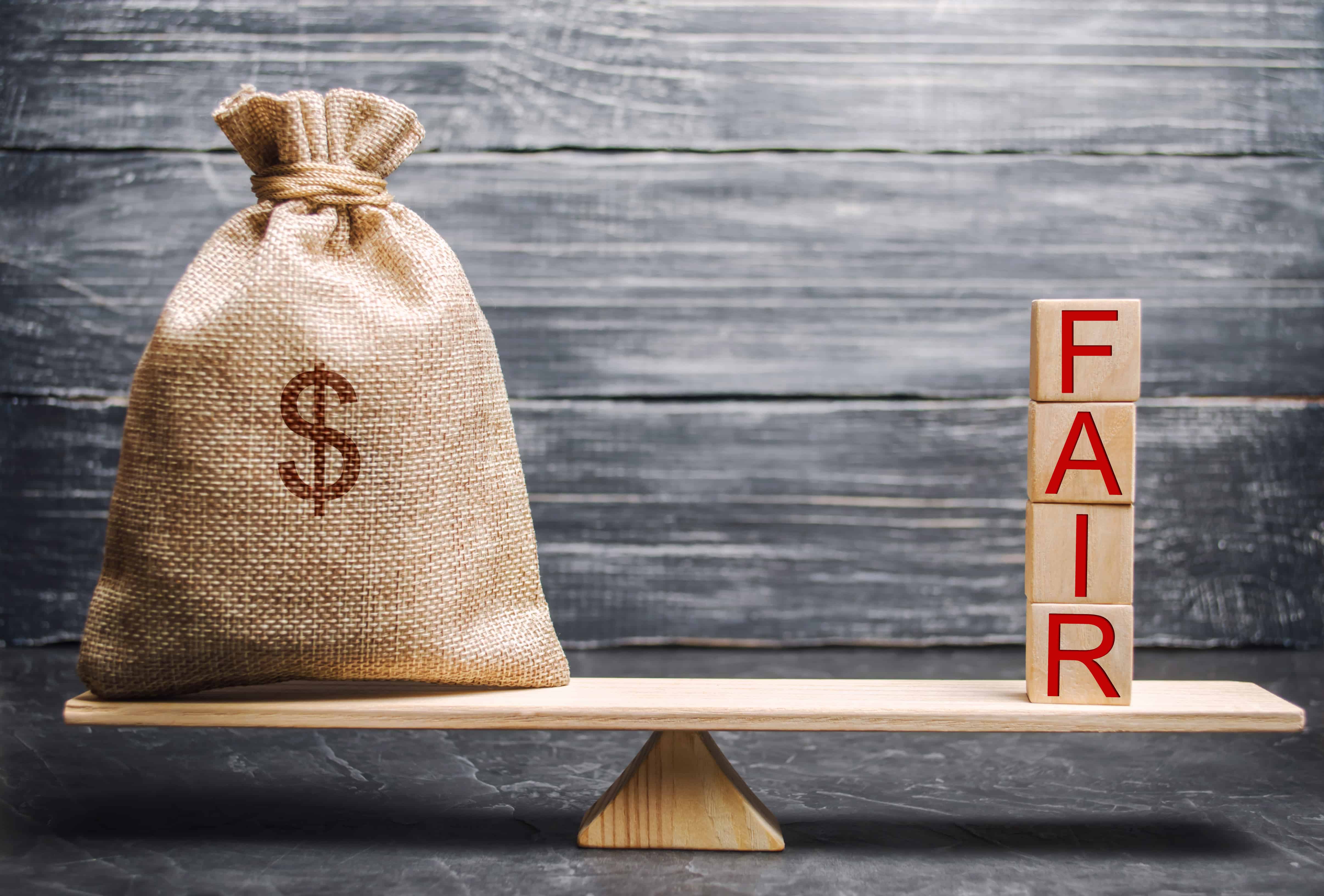 Money,Bag,And,Wooden,Blocks,With,The,Word,Fair.,Balance.
